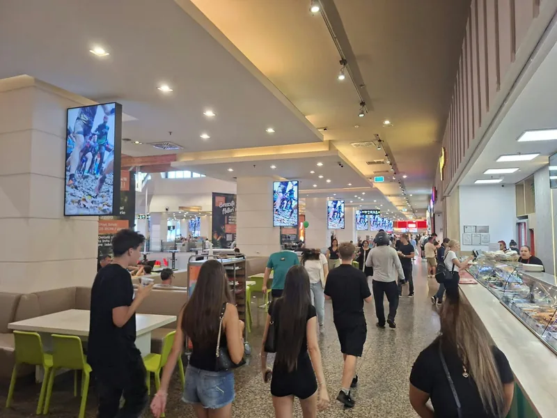 Digital screens above the Iulius Mall food court